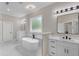 Bright primary bath with standalone tub, double vanities and great natural light at 1461 Leach Dr, Lawrenceville, GA 30045