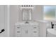Bathroom vanity featuring marble counters, undermount sink, black hardware, and large mirror, adjacent to a standalone tub at 1461 Leach Dr, Lawrenceville, GA 30045