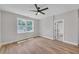 Bright bedroom features hardwood floors, ceiling fan, and a view to the backyard at 1461 Leach Dr, Lawrenceville, GA 30045
