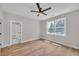 Bright bedroom features hardwood floors, ceiling fan, and a view to the backyard at 1461 Leach Dr, Lawrenceville, GA 30045