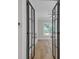 Bedroom with modern glass doors has a window view of lush greenery, creating a serene retreat at 1461 Leach Dr, Lawrenceville, GA 30045