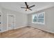 Bright bedroom with hardwood floors, ceiling fan, neutral walls, and natural light from the backyard at 1461 Leach Dr, Lawrenceville, GA 30045