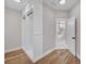 Walk-in closet with wood floors, custom shelves, and door to primary bathroom with standalone tub at 1461 Leach Dr, Lawrenceville, GA 30045