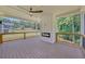 Deck featuring a gas fireplace, ceiling fan, wood floors, black railings, and backyard views at 1461 Leach Dr, Lawrenceville, GA 30045