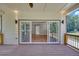 Covered back deck with view into home's living space featuring hardwood floors and a backyard view at 1461 Leach Dr, Lawrenceville, GA 30045
