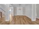 Open dining room with hardwood floors, white wainscoting, elegant chandelier, and view to the stairway at 1461 Leach Dr, Lawrenceville, GA 30045