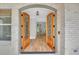 Elegant entryway with double wooden doors and hardwood floors at 1461 Leach Dr, Lawrenceville, GA 30045