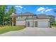 Rear exterior showcasing a three-car garage and a small second story balcony at 1461 Leach Dr, Lawrenceville, GA 30045
