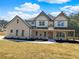 Stunning two-story home with a welcoming front porch and beautiful stone and siding exterior at 1461 Leach Dr, Lawrenceville, GA 30045