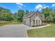 Beautiful exterior elevation with a three-car garage, lush lawn, and professional landscaping at 1461 Leach Dr, Lawrenceville, GA 30045