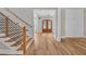 View of the light-filled foyer showcasing stairs, hardwood floors, and shiplap wall at 1461 Leach Dr, Lawrenceville, GA 30045