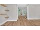 Spacious foyer with hardwood flooring, floating shelves and ample natural light at 1461 Leach Dr, Lawrenceville, GA 30045