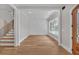 Bright foyer with hardwood floors, modern staircase, and decorative wall paneling at 1461 Leach Dr, Lawrenceville, GA 30045