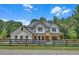 Charming two-story home with a modern farmhouse design, fenced yard, and beautifully maintained landscaping at 1461 Leach Dr, Lawrenceville, GA 30045