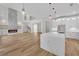 Modern kitchen with a quartz island, white cabinets, and an open view of the living room and fireplace at 1461 Leach Dr, Lawrenceville, GA 30045