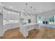Modern kitchen boasts white cabinets, granite countertops, an island, and stainless steel appliances at 1461 Leach Dr, Lawrenceville, GA 30045