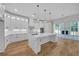 Elegant kitchen with an island and stainless steel appliances, complemented by ample natural light at 1461 Leach Dr, Lawrenceville, GA 30045