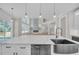 A large kitchen island features white countertops, a stainless sink, and modern fixtures and finishes at 1461 Leach Dr, Lawrenceville, GA 30045