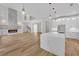 Spacious kitchen with white cabinets, stainless steel appliances, island, and an open view of the living room at 1461 Leach Dr, Lawrenceville, GA 30045