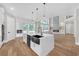 Modern kitchen boasts a large island with white countertops, black sink, and stainless steel appliances at 1461 Leach Dr, Lawrenceville, GA 30045