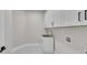 New laundry room with white cabinets, gray tile floors, and stainless steel sink at 1461 Leach Dr, Lawrenceville, GA 30045