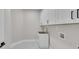 Functional laundry room with white cabinetry, a sink, and tile flooring at 1461 Leach Dr, Lawrenceville, GA 30045