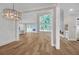Open-concept living room with hardwood floors, a fireplace, and large windows that provide plenty of natural light at 1461 Leach Dr, Lawrenceville, GA 30045