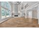 Spacious living room with a stone fireplace, tall windows, hardwood floors, and an upper level overlook at 1461 Leach Dr, Lawrenceville, GA 30045