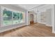 Bright living room features hardwood floors, large windows, and a decorative wood and glass front door at 1461 Leach Dr, Lawrenceville, GA 30045