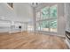 Bright living room with an open floor plan that flows into the kitchen and features large windows at 1461 Leach Dr, Lawrenceville, GA 30045