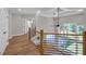 Spacious loft area showcasing hardwood floors and a modern railing overlooking the living space at 1461 Leach Dr, Lawrenceville, GA 30045