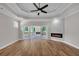 Light-filled main bedroom with hardwood floors and a fireplace leading to the covered deck at 1461 Leach Dr, Lawrenceville, GA 30045