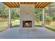 Covered patio features an inviting brick fireplace, perfect for outdoor entertaining in a serene setting at 1461 Leach Dr, Lawrenceville, GA 30045