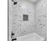 Modern shower featuring white marble-style tiles, black fixtures, and a built-in niche at 1461 Leach Dr, Lawrenceville, GA 30045