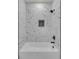 Modern shower features white marble-style tiles, black fixtures, and a built-in niche at 1461 Leach Dr, Lawrenceville, GA 30045