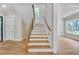 Staircase with modern railing design offers an open and bright transition between floors at 1461 Leach Dr, Lawrenceville, GA 30045