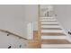 Beautiful staircase with oak treads, white risers and a wooden handrail leads to the upper level at 1461 Leach Dr, Lawrenceville, GA 30045
