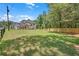 The sprawling front yard of the elegant house, surrounded by lush greenery and a dark wood fence at 1461 Leach Dr, Lawrenceville, GA 30045