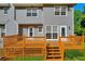 Wooden back deck with stairs leading to the spacious and grassy backyard at 2151 Hamstead Ct, Suwanee, GA 30024