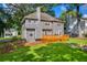 Backyard with wooden deck, stone fire pit, and lush green grass at 2151 Hamstead Ct, Suwanee, GA 30024