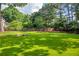 Large, well-maintained backyard with green grass and a stone fire pit at 2151 Hamstead Ct, Suwanee, GA 30024