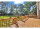 Expansive wood deck overlooking a large backyard with lush green grass and mature trees at 2151 Hamstead Ct, Suwanee, GA 30024