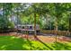 Backyard with a parked camper, surrounded by trees and a wooden fence at 2151 Hamstead Ct, Suwanee, GA 30024