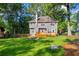 Spacious backyard with lush lawn, wooden deck, and a stone fire pit at 2151 Hamstead Ct, Suwanee, GA 30024