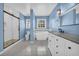 Modern bathroom with blue walls, a soaking tub, a dual-sink vanity, and a glass-enclosed shower at 2151 Hamstead Ct, Suwanee, GA 30024
