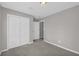Cozy bedroom featuring gray carpet floor, gray walls, and a double door closet with white trim at 2151 Hamstead Ct, Suwanee, GA 30024