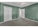 View of a bedroom with green walls, carpet and view to the hallway at 2151 Hamstead Ct, Suwanee, GA 30024