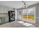 Bright breakfast nook with large windows, a view to the backyard and access to the deck at 2151 Hamstead Ct, Suwanee, GA 30024