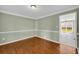 Charming dining room with hardwood floors, crown molding, and a view into an adjacent room at 2151 Hamstead Ct, Suwanee, GA 30024