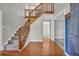 Grand foyer featuring hardwood floors, a staircase with wood banister, and an open floor plan at 2151 Hamstead Ct, Suwanee, GA 30024